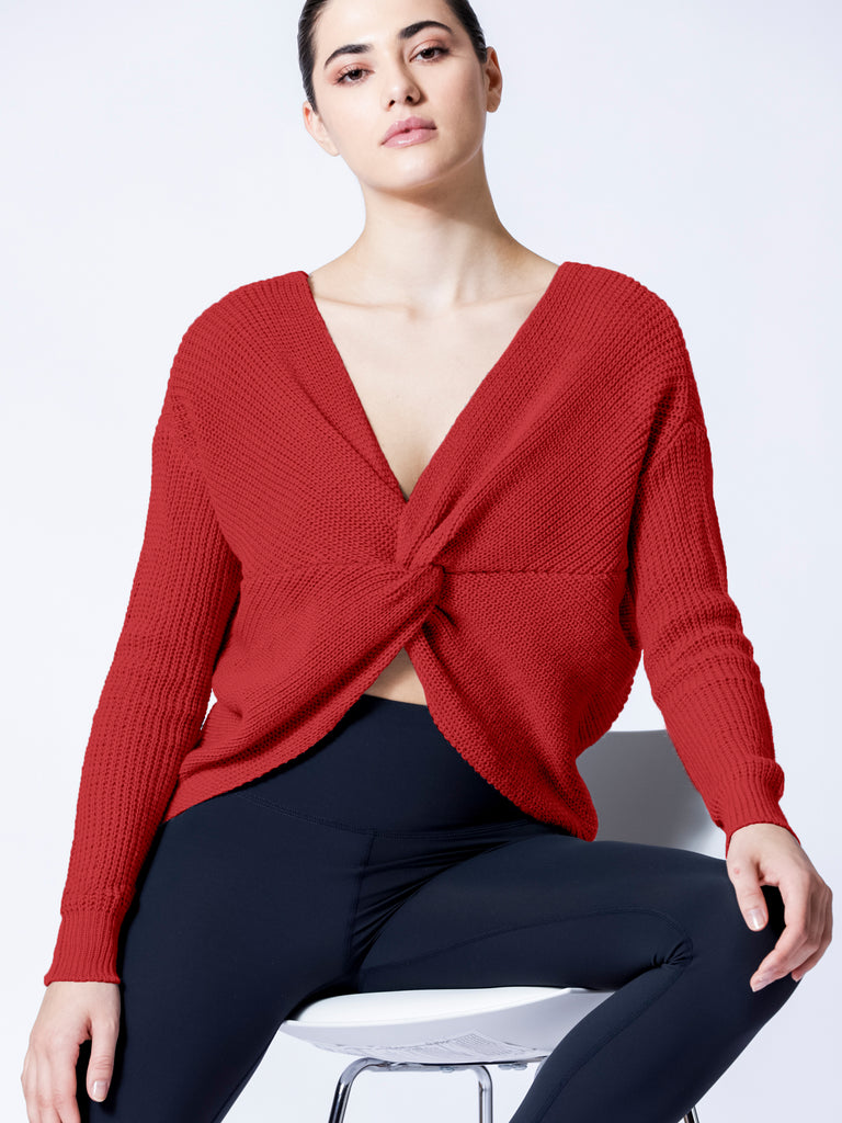 Open back knit sweater in red, worn with knot in the front